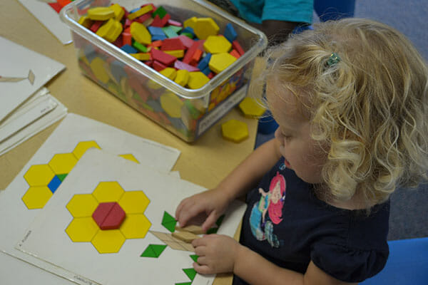 Learning Paths Academy, Preschool Explorer Program, Little girl doing a puzzle