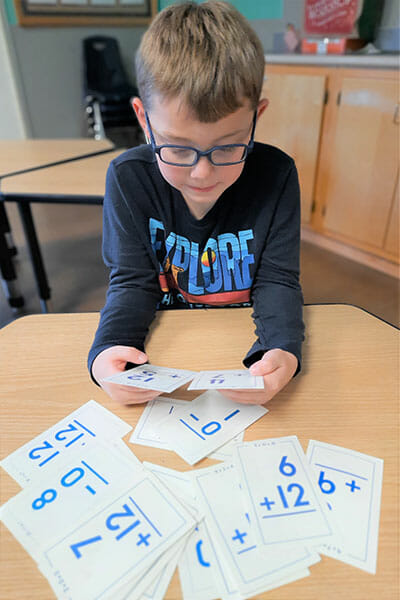 Learning Paths Academy, Youth Zone Program, Little boy learning math through flash cards